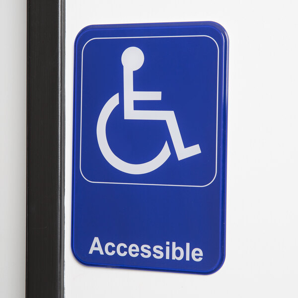 A blue and white Thunder Group handicap accessible sign with a white symbol on it.
