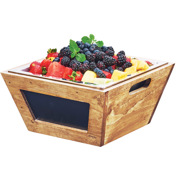 A Cal-Mil Madera rustic pine folding riser on a table with fruit in it.