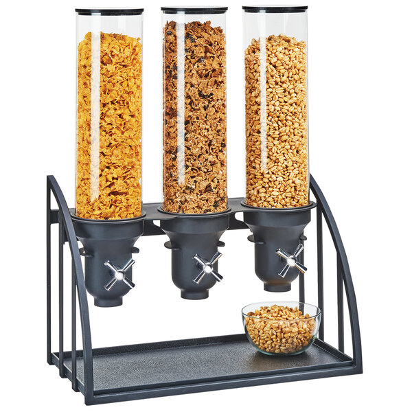 A black Cal-Mil triple cereal dispenser with glass containers filled with cereal.