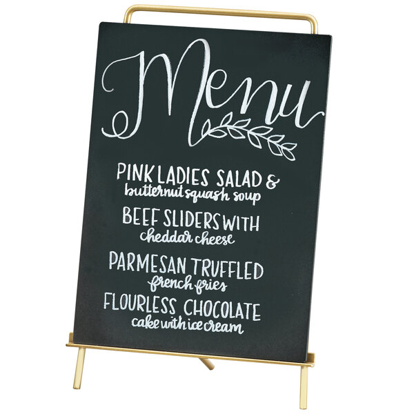 A Cal-Mil brass menu sign holder with white writing on a chalkboard.