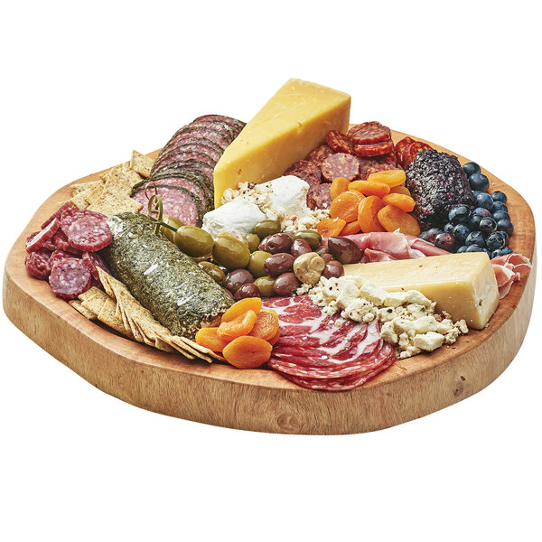A Cal-Mil natural wood serving board with a platter of meat and cheese.