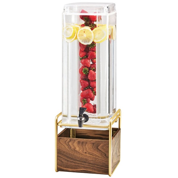 A Cal-Mil Mid-Century beverage dispenser with an infusion chamber filled with water, strawberries, and lemons.
