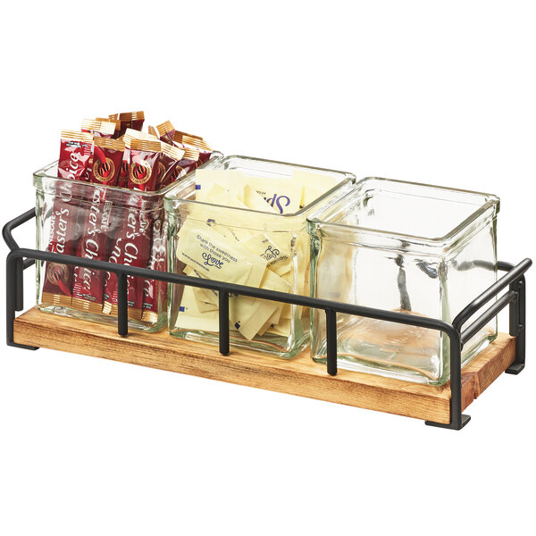 A Cal-Mil Madera rustic pine and metal organizer tray with three square glass jars.