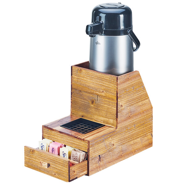 A Cal-Mil Madera wood two tier airpot stand with a drawer holding two containers.