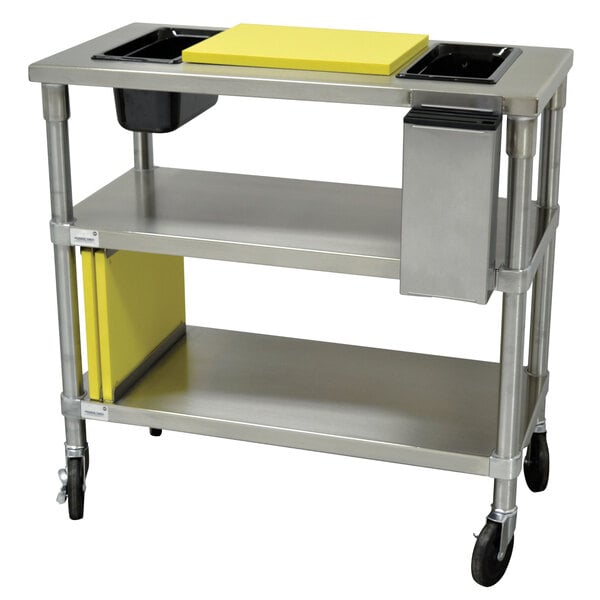 A stainless steel Advance Tabco chicken cutting station with a yellow rectangular block on top.