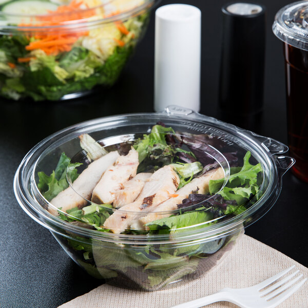 A salad in a Dart plastic tamper-evident bowl with a flat white lid.