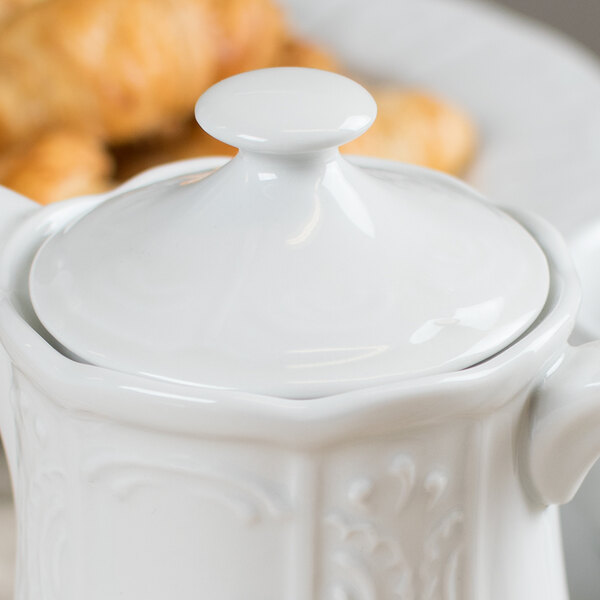 A Tuxton Chicago Bright White ceramic teapot lid.