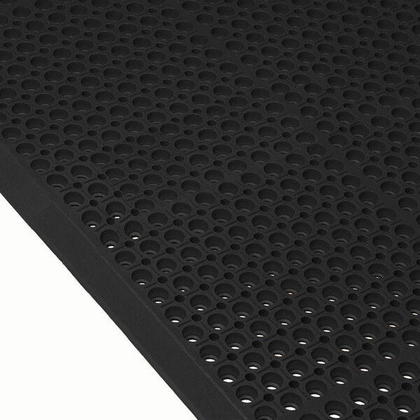 A black Cactus Mat with holes and beveled edges.