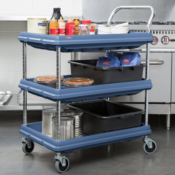 A blue Metro utility cart with three shelves holding food items.
