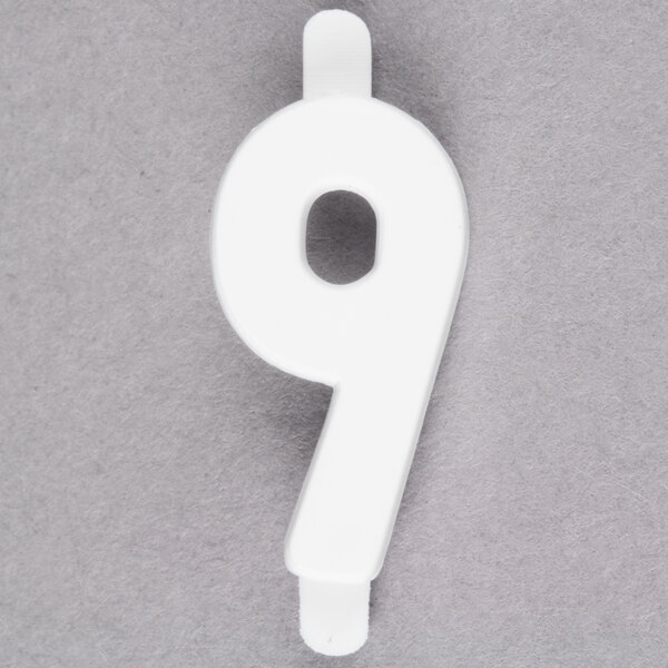 A white molded plastic number 9 deli tag insert.