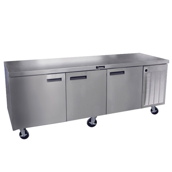 A stainless steel Delfield undercounter refrigerator with three doors.