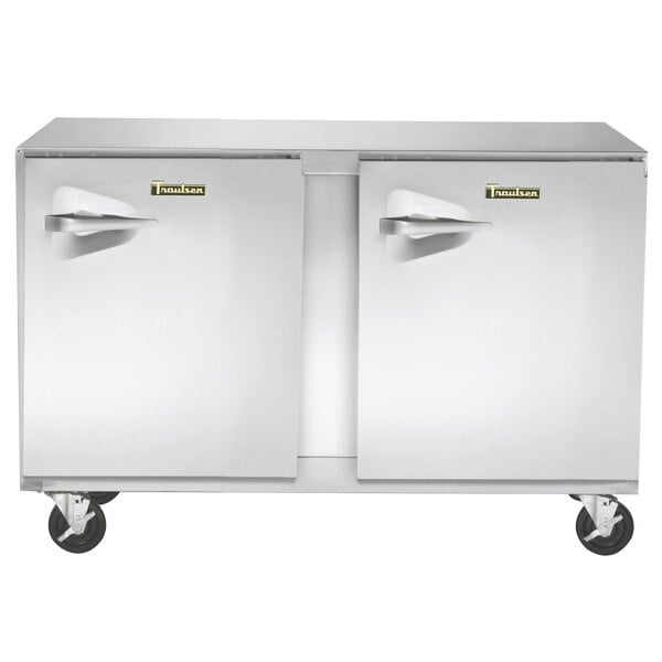 A close-up of a Traulsen stainless steel undercounter freezer with two right hinged doors.