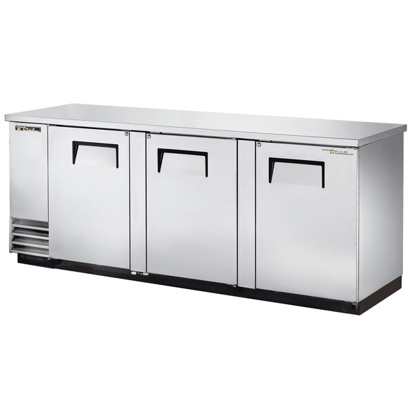 A True stainless steel pass-through back bar refrigerator with three solid doors.
