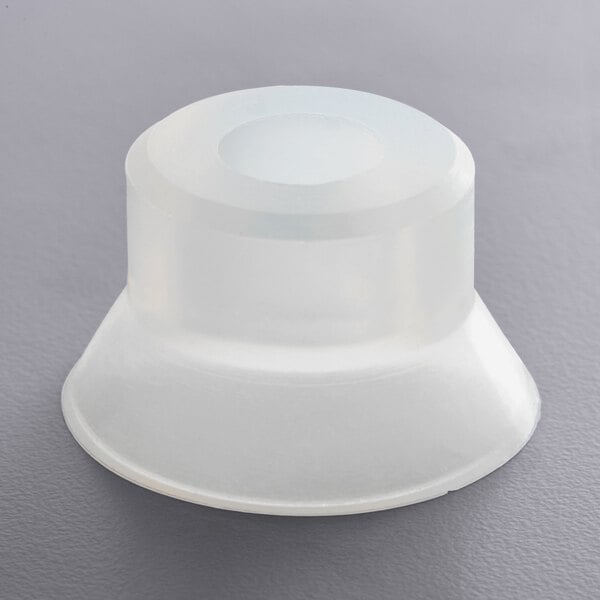 A white plastic cap for a Bunn auger shaft seal on a gray surface.