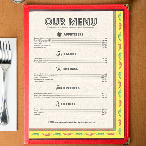 Menu paper with a Southwest themed Mariachi design on a table with a fork and knife.