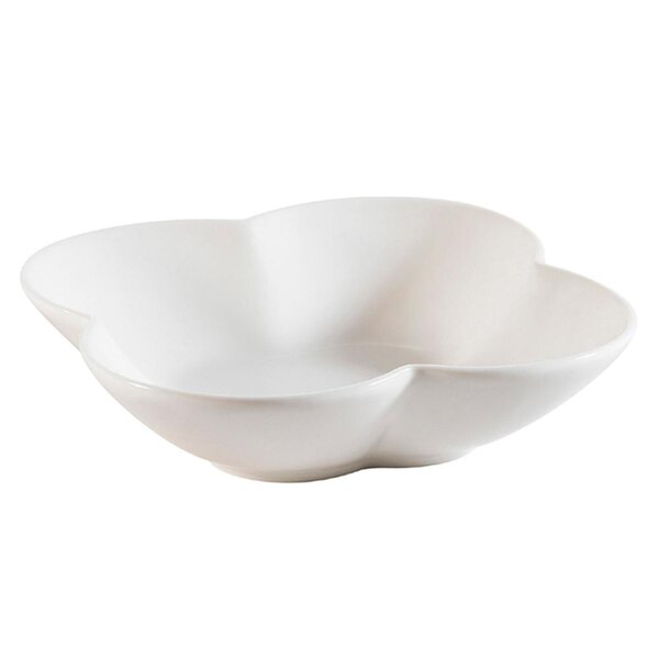 A bone white porcelain bowl with a flower shaped design.
