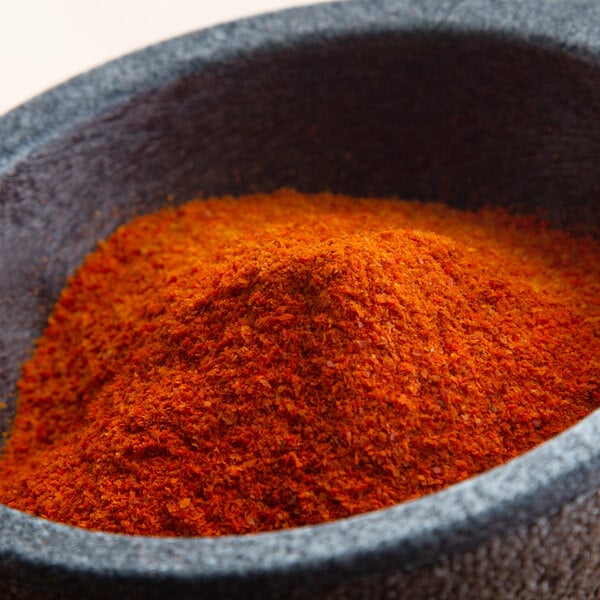 A white bowl filled with Regal Ground Cayenne Pepper.