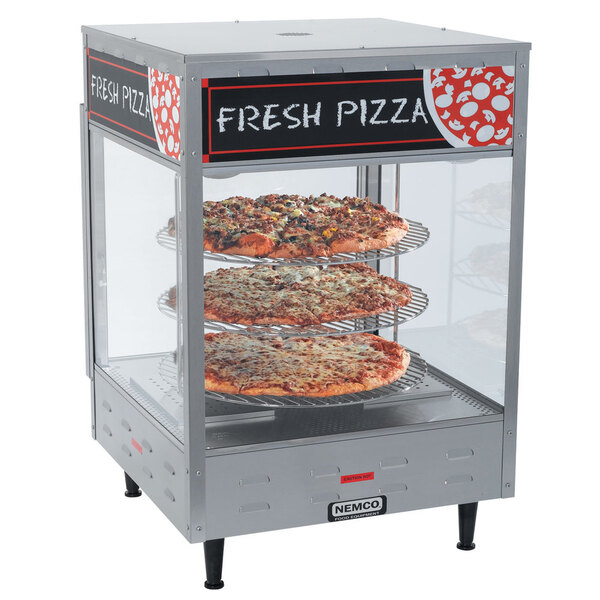 A Nemco pizza merchandiser with pizza on display.