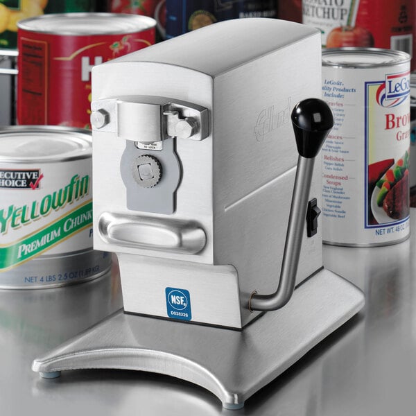 A white Edlund tabletop electric can opener opening a can of soup.
