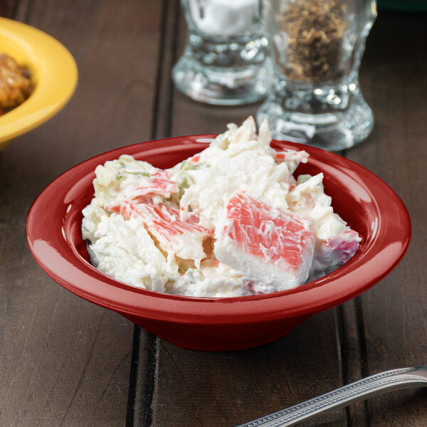A bowl of crab salad in a GET Diamond Harvest cranberry melamine bowl.