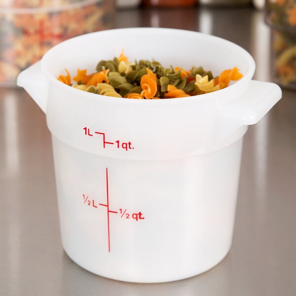 A white Cambro round food storage container filled with pasta.