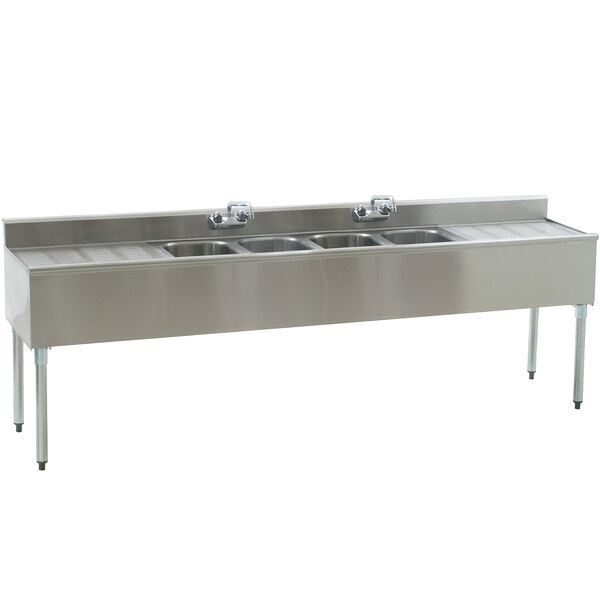 A stainless steel Eagle Group underbar sink with four compartments and two drainboards.