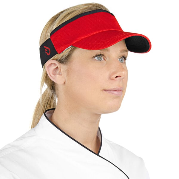 A woman in a chef's uniform wearing a red Headsweats visor.