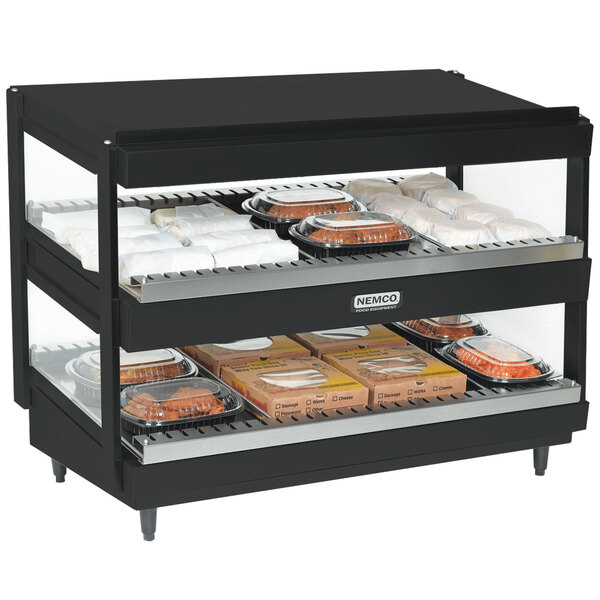 A black Nemco countertop slanted double shelf food warmer with trays of food on it.