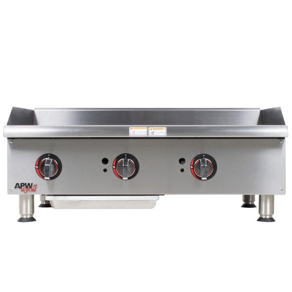 An APW Wyott stainless steel countertop gas griddle with knobs.