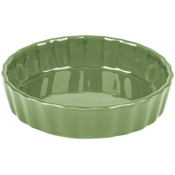 A green fluted china quiche dish with a rim.