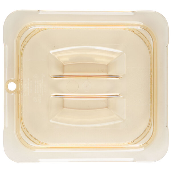 A Carlisle amber plastic lid with a handle on a plastic container.