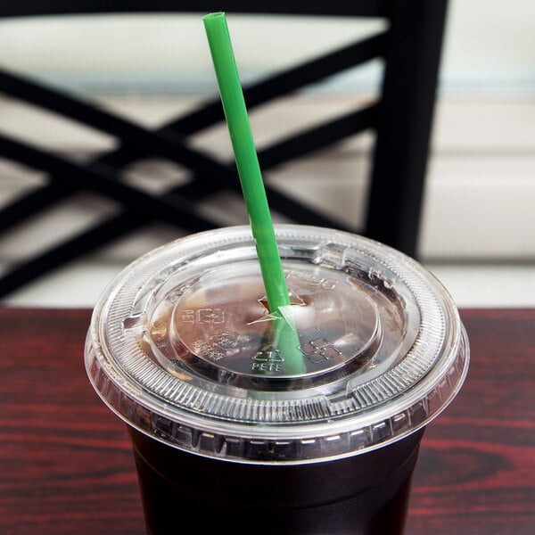 A plastic cup with a green Eco-Products straw in it.
