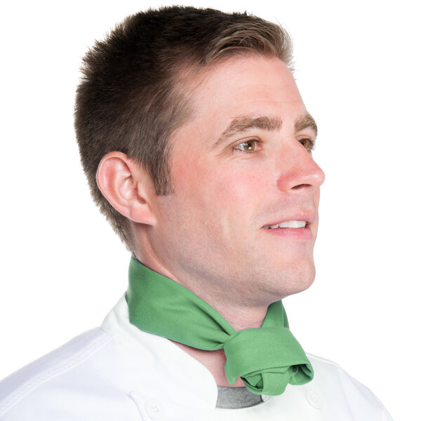 A man in a chef's uniform wearing a seafoam green chef neckerchief.