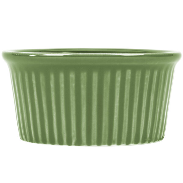 A close-up of a green fluted ramekin with a striped pattern.