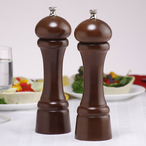 A brown wooden Chef Specialties Windsor salt and pepper mill set on a table.