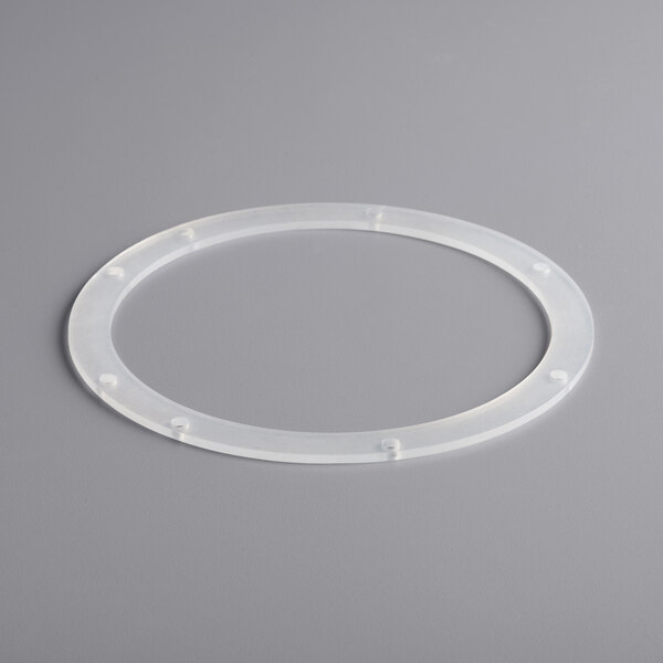 A white plastic circle with holes.
