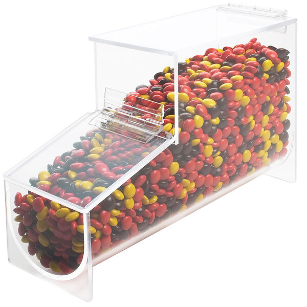 A clear plastic Cal-Mil topping dispenser filled with candy.