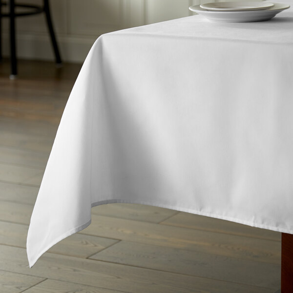 A white Intedge tablecloth on a table.
