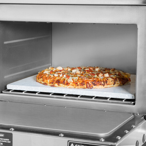 A pizza baking on a TurboChef baking stone in a commercial oven.
