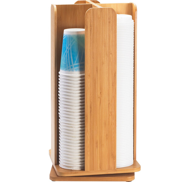 A Cal-Mil bamboo revolving cup and lid organizer with cups in it.