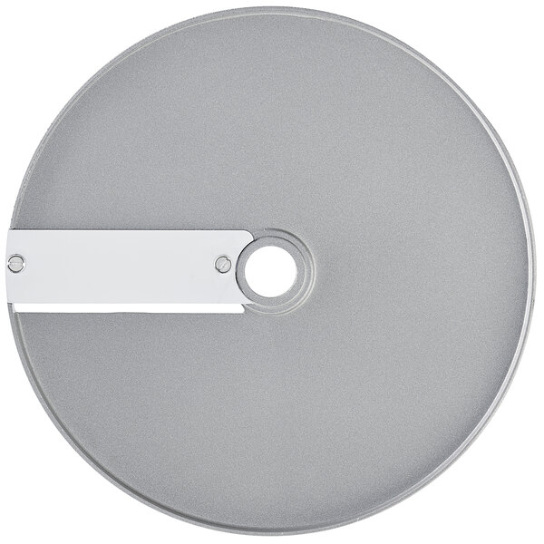 A silver circular Robot Coupe slicing disc with a hole in the center and a white label.