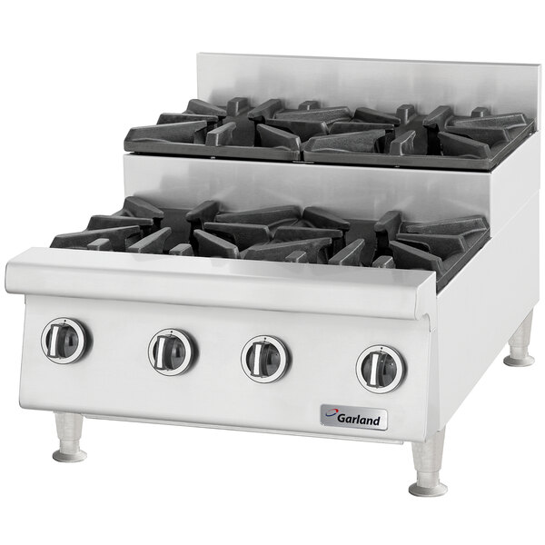A stainless steel Garland countertop range with six burners.