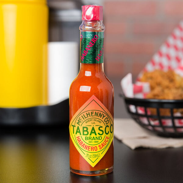 A close up of a bottle of TABASCO Habanero Hot Sauce on a table.