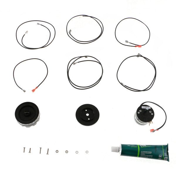 A Hobart service kit for dishwasher parts with a black circle with a hole in it, black wires, and a tube of glue.