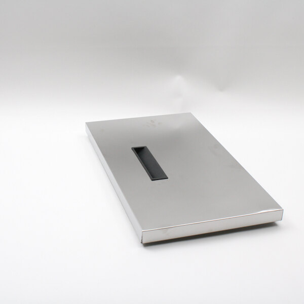 A silver rectangular object with a black handle.