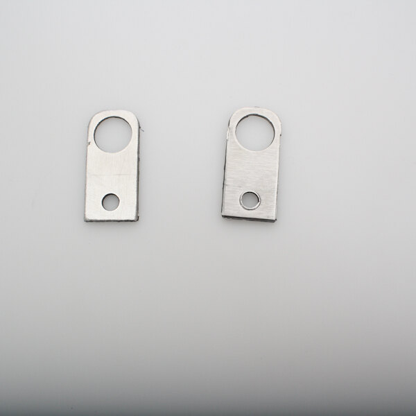 A pair of metal APW Wyott bearing clips with holes.