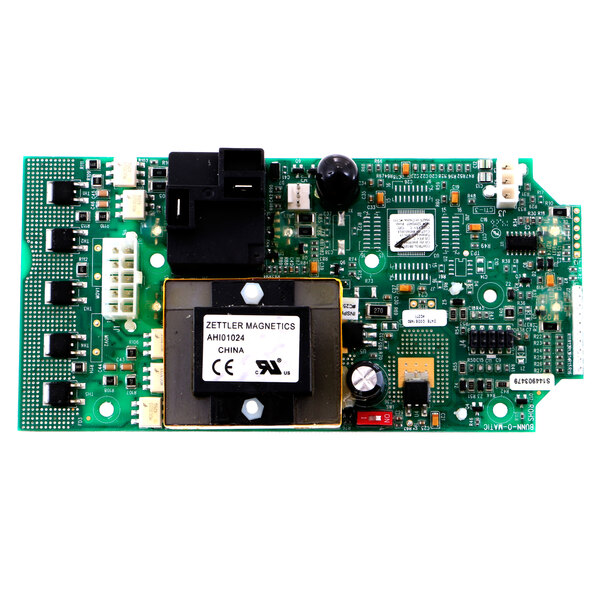 A green circuit board with black and white components and a white label with black text.