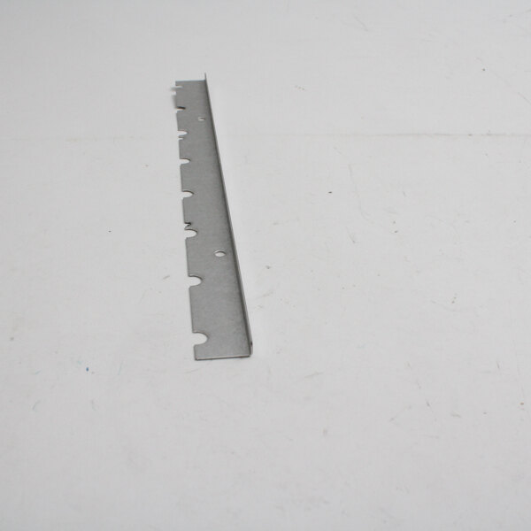 A metal strip with a hole in it on a white surface.