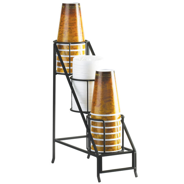 A black metal Cal-Mil countertop organizer with three tiers holding cups and lids.