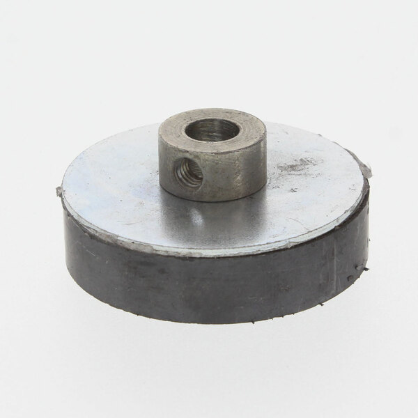 A Grindmaster Cecilware drive magnet, a round metal disc with a hole and a nut.